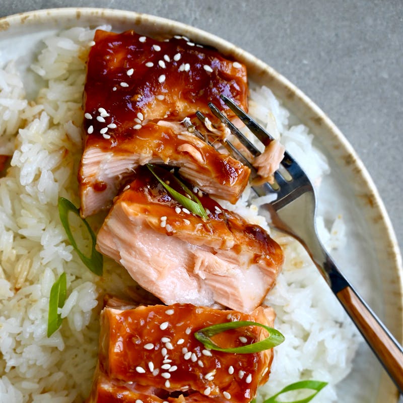 Honey garlic salmon on a bed of steamed white rice.