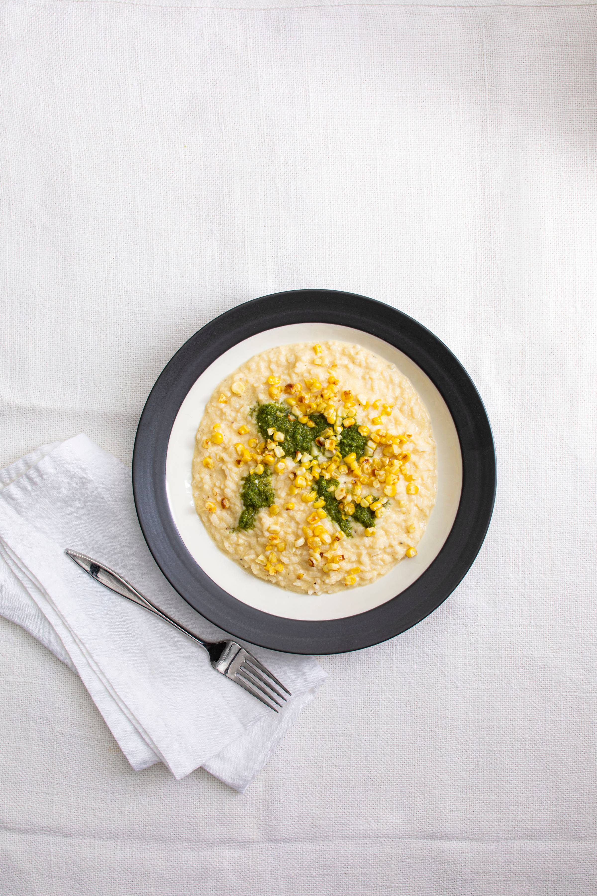 Bowl of creamy sweet corn risotto and green mint chutney