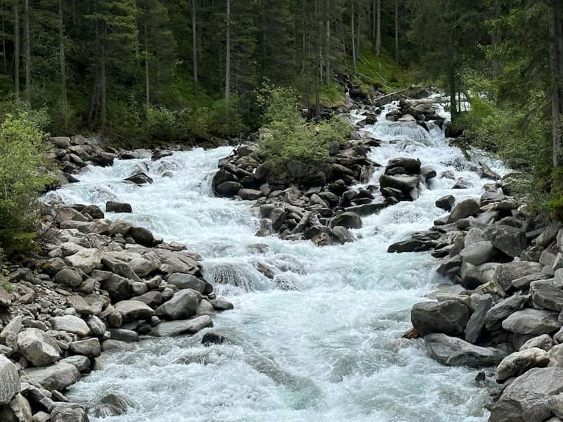 A rushing river flows through a rocky landscape.