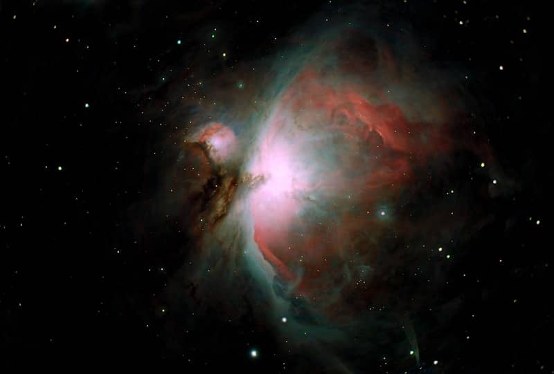 Orion nebula glows with cosmic dust and gas.