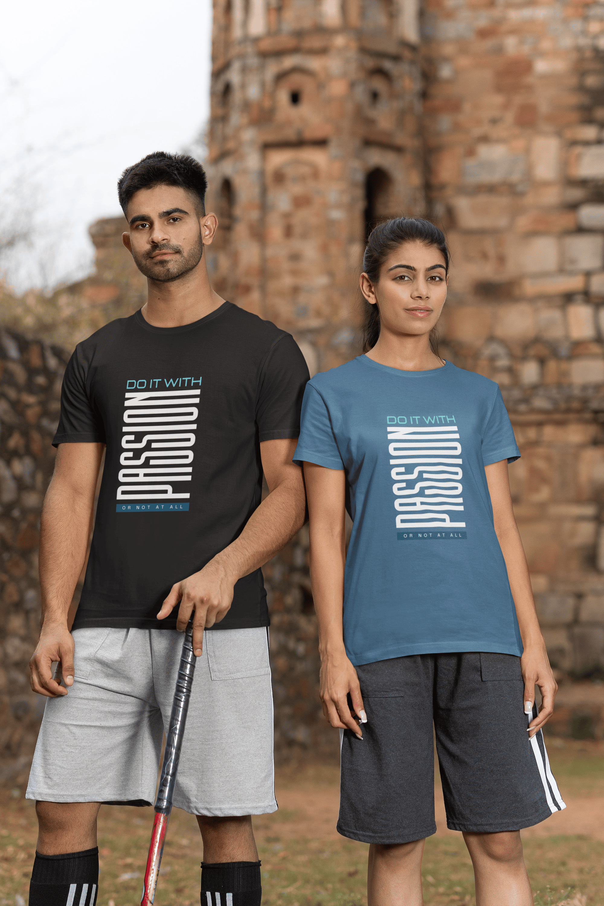 Two cricket players wearing t-shirts that say, "Do it with passion or not at all." 