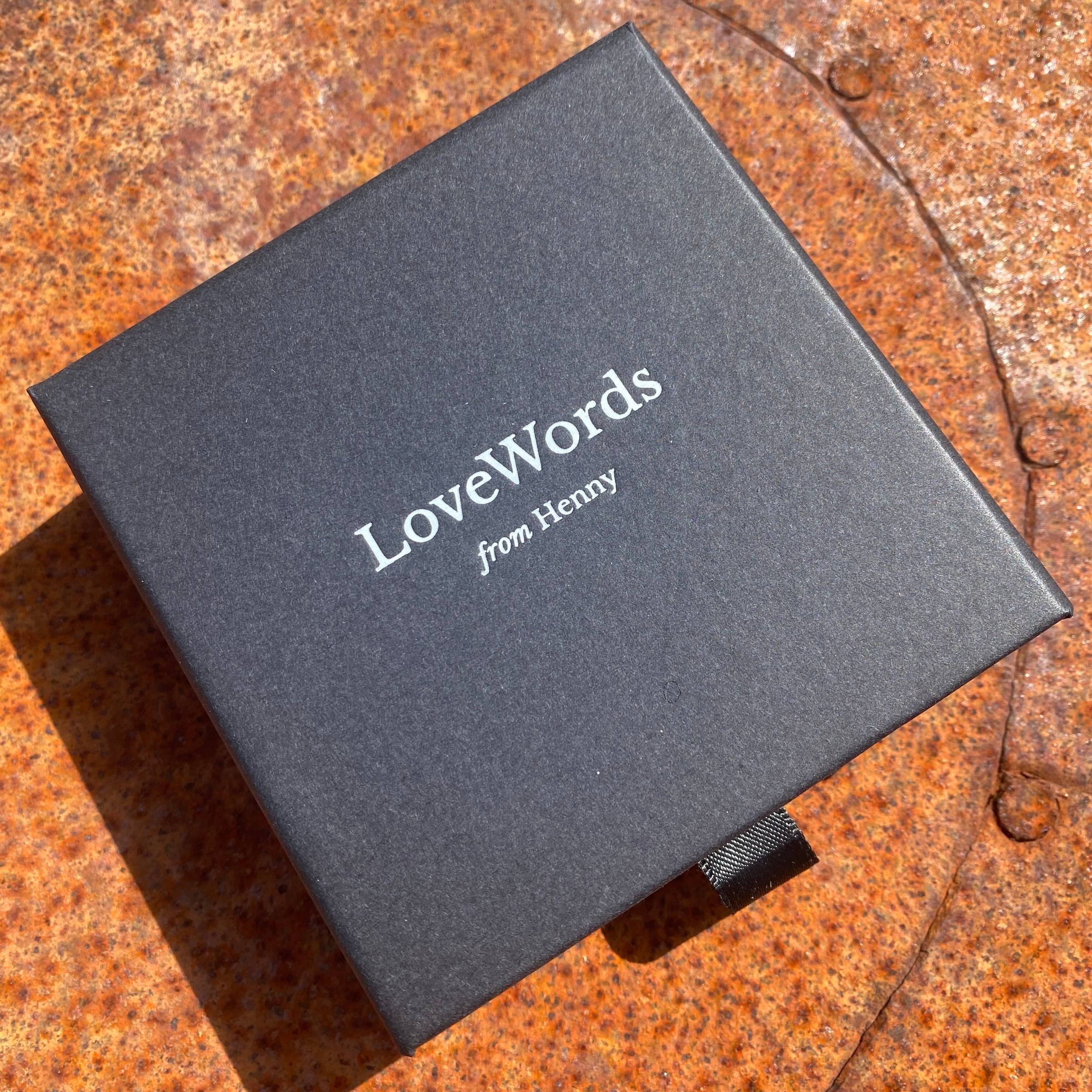 A small black box holding modern oracle cards - LoveWords from Henny