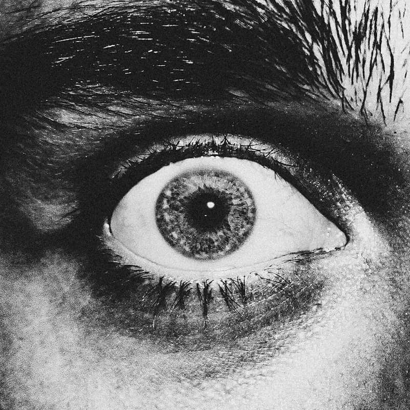 A black and white photo of a man's eye