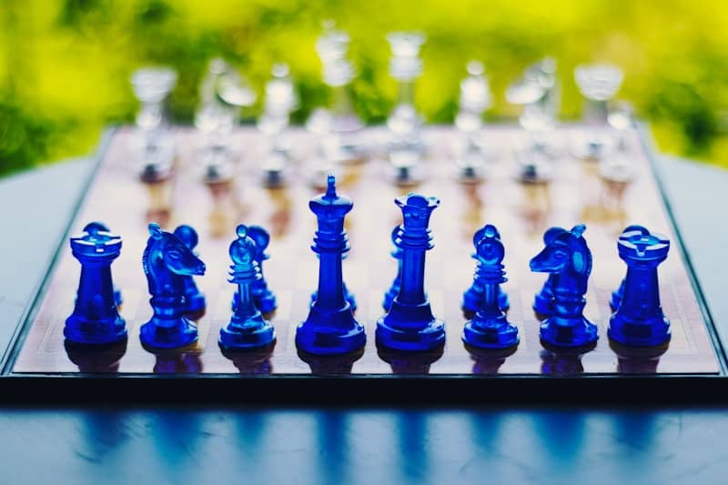 blue chess piece on black metal fence