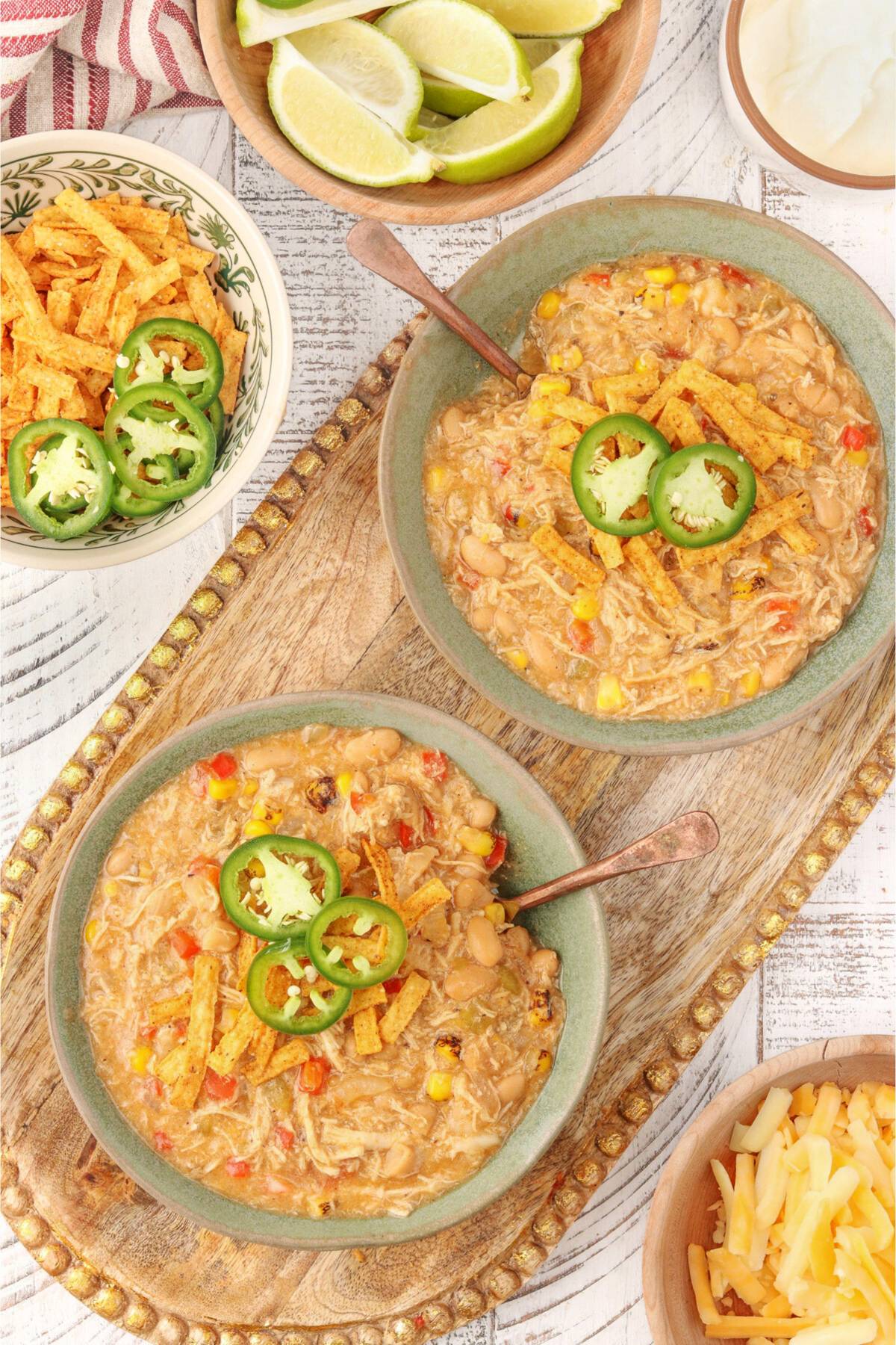 2 green bowls filled with creamy white bean chicken chili.