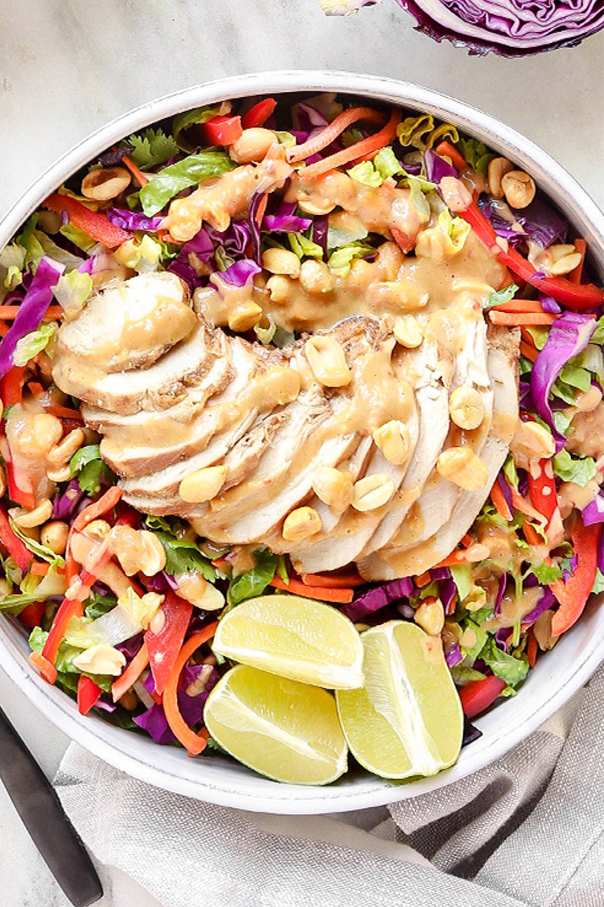 Thai chicken crunch salad with sliced rotisserie chicken, cabbage, carrots, bell pepper, peanuts, and peanut sauce.