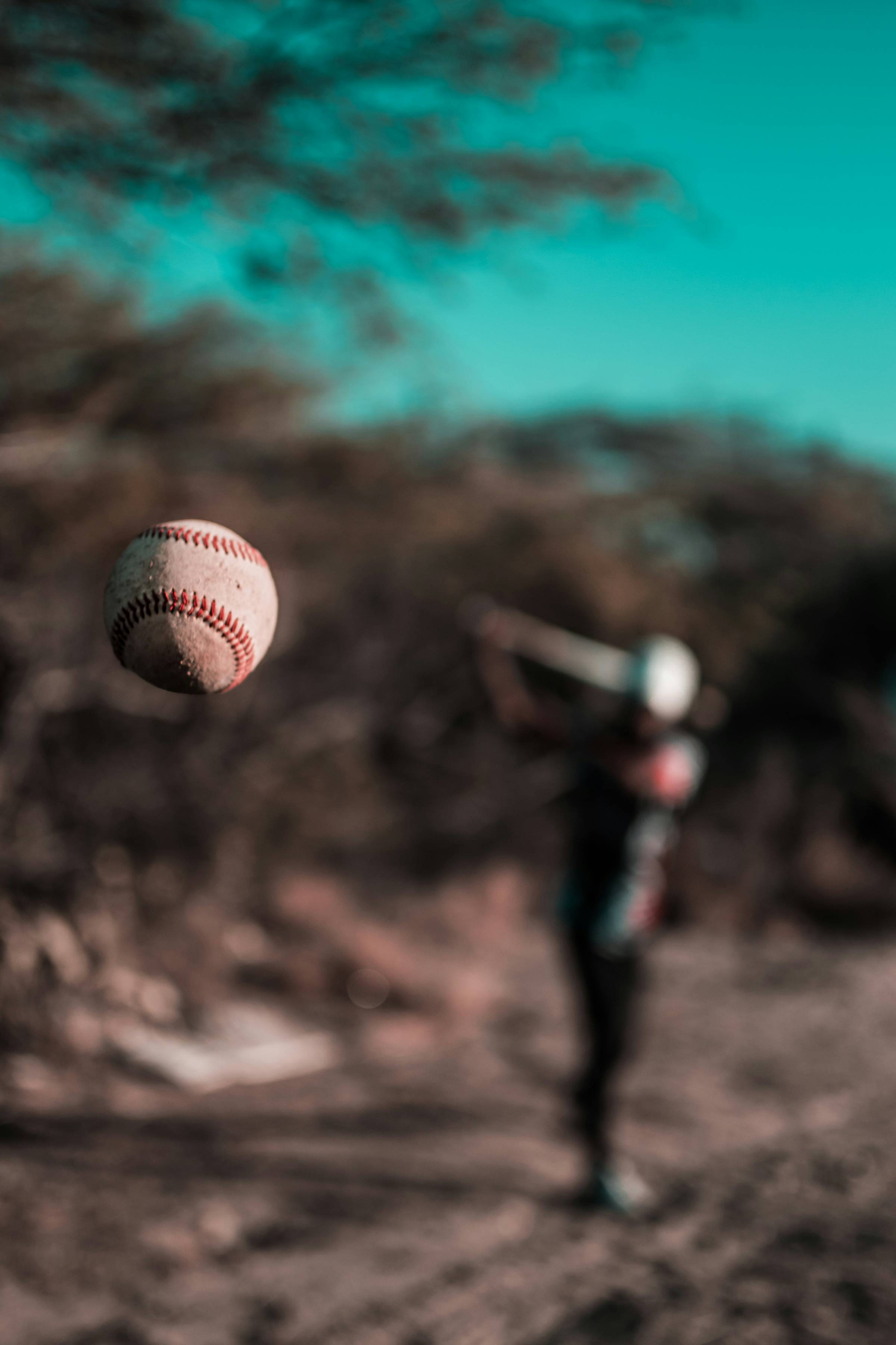 baseball in air towards a batter