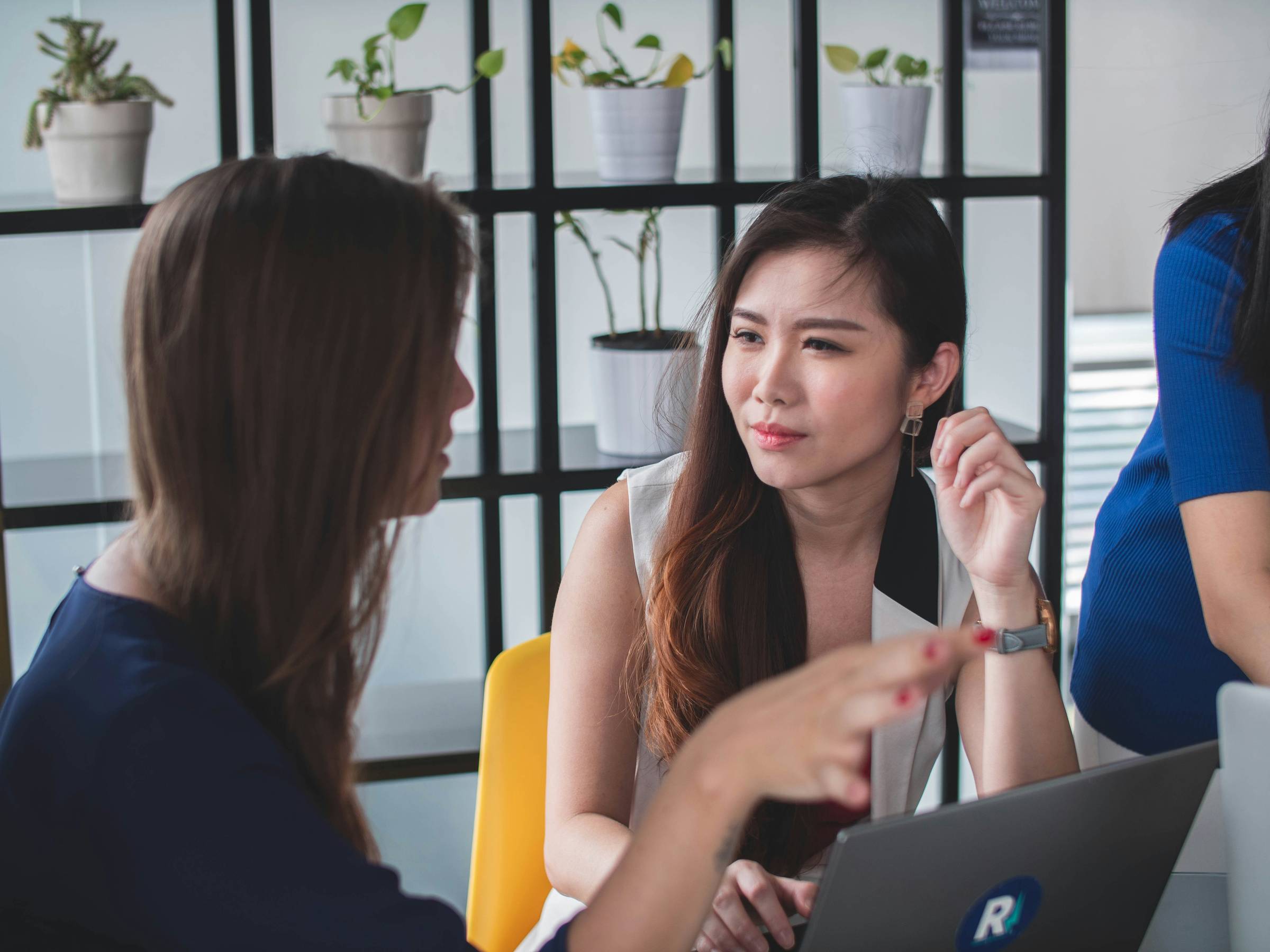 Woman listens to another woman talking