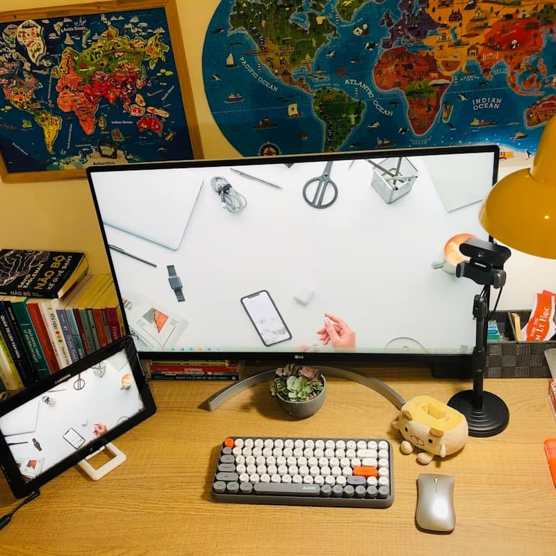 A desk with a computer monitor, keyboard and mouse