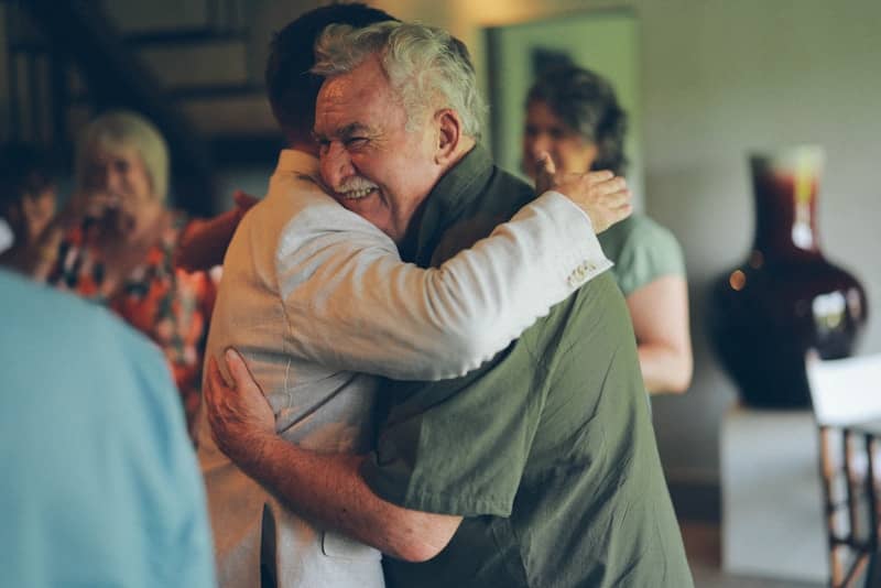 Family members hugging warmly at a family gathering