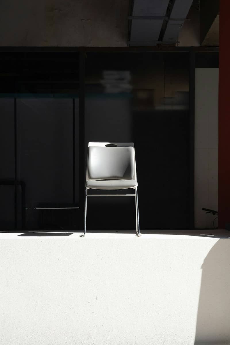 A single modern chair in a brightly lit room