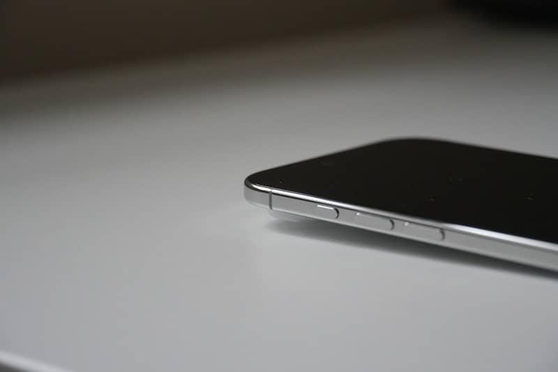 Close-up of a smartphone on a white surface.