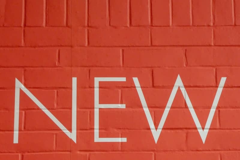 The word NEW emblazoned on a red brick wall
