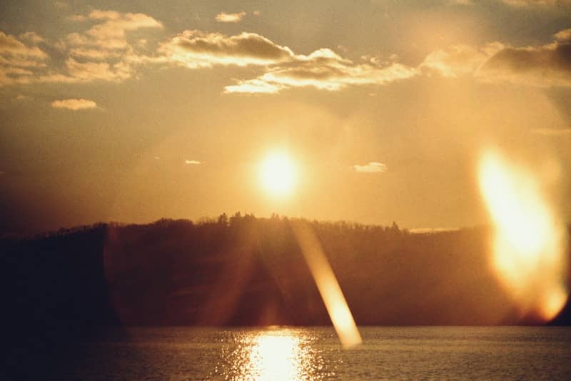Sunset over a calm body of water.