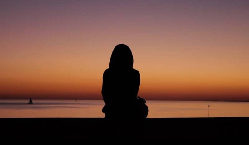 Silhouette of person watching sunset over the ocean