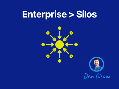 Graphic with the words ‘Enterprise > Silos’ above a central hub-and-spoke icon, with a small photo of Dan Giroux in the corner.