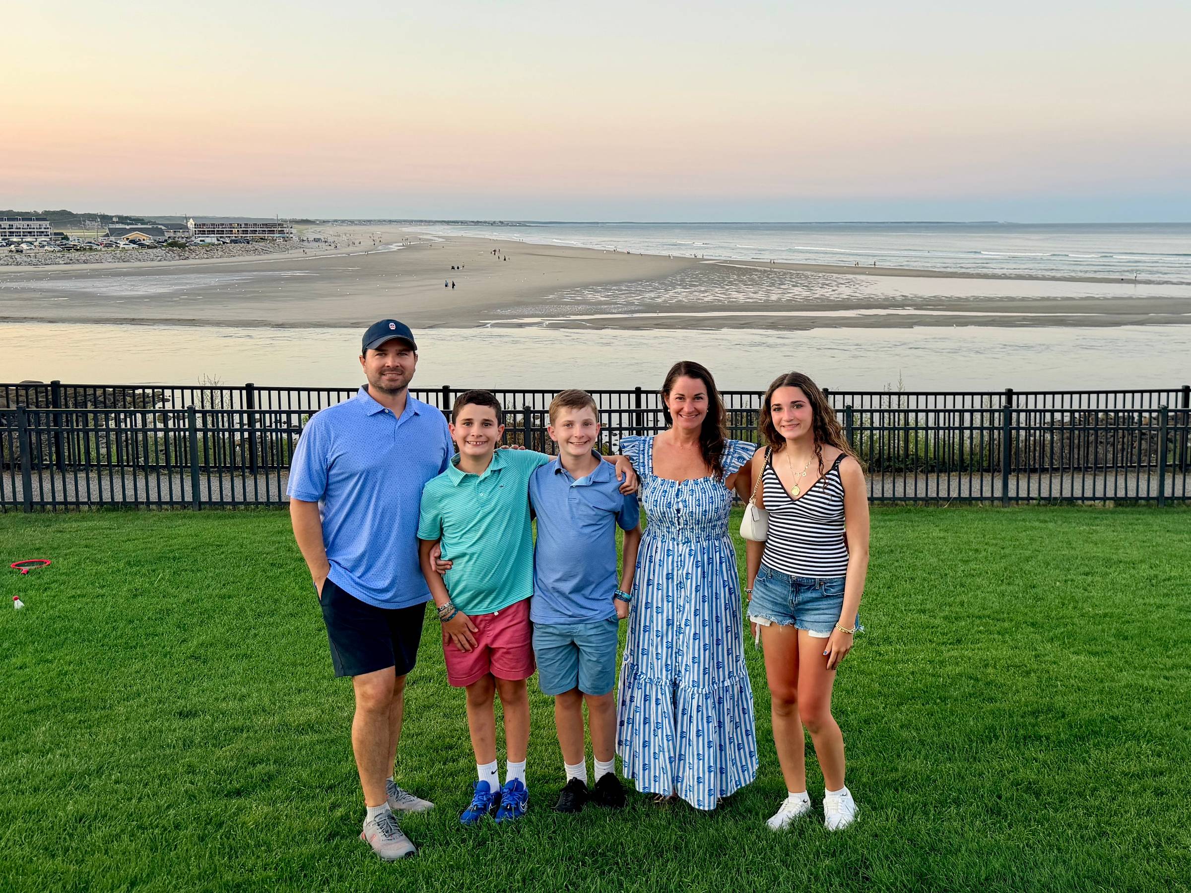 Dan Giroux with his wife and three children standing together at sunset overlooking the beach in Ogunquit, Maine.