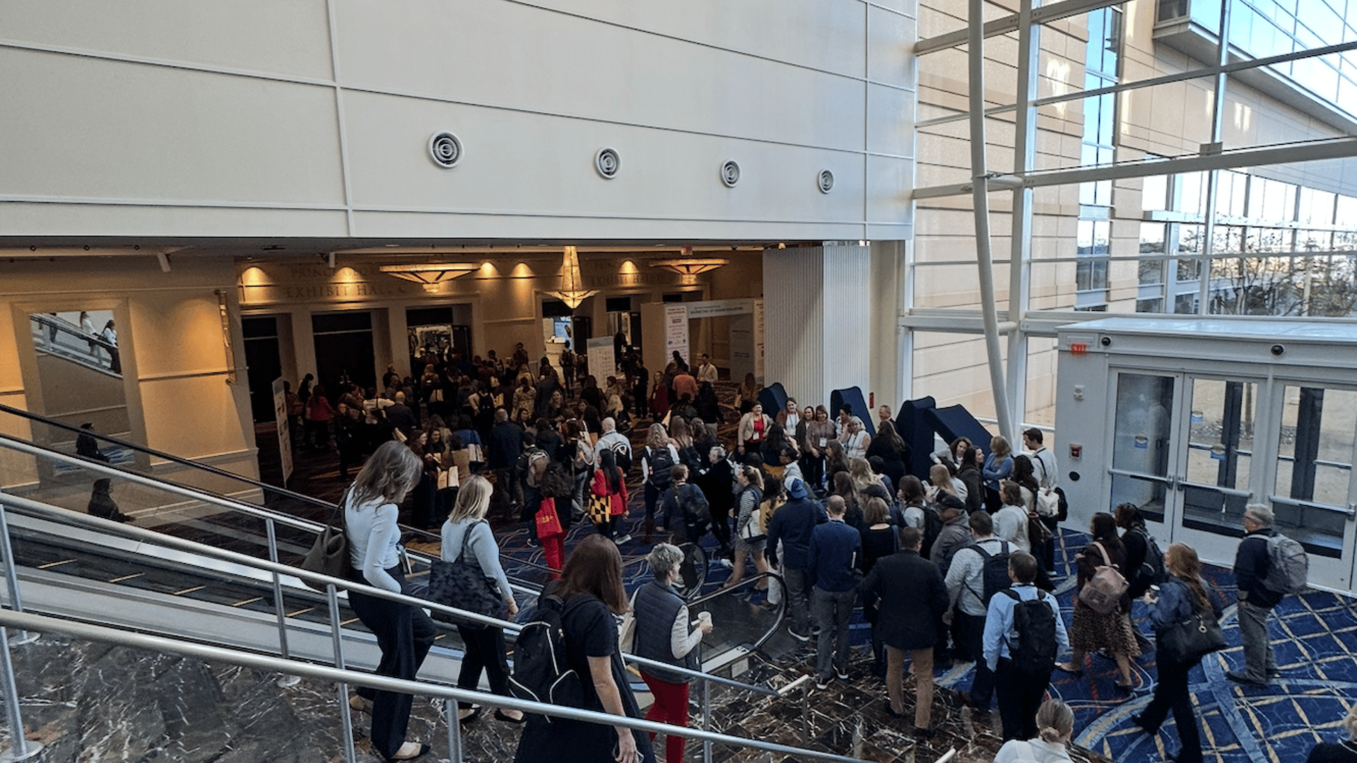 attendees coming down the escalator