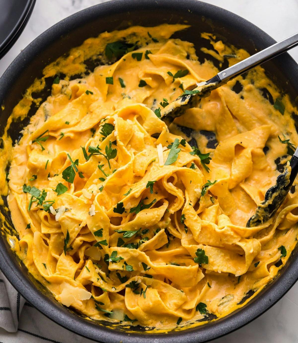 creamy pumpkin alfredo with noodles in a skillet