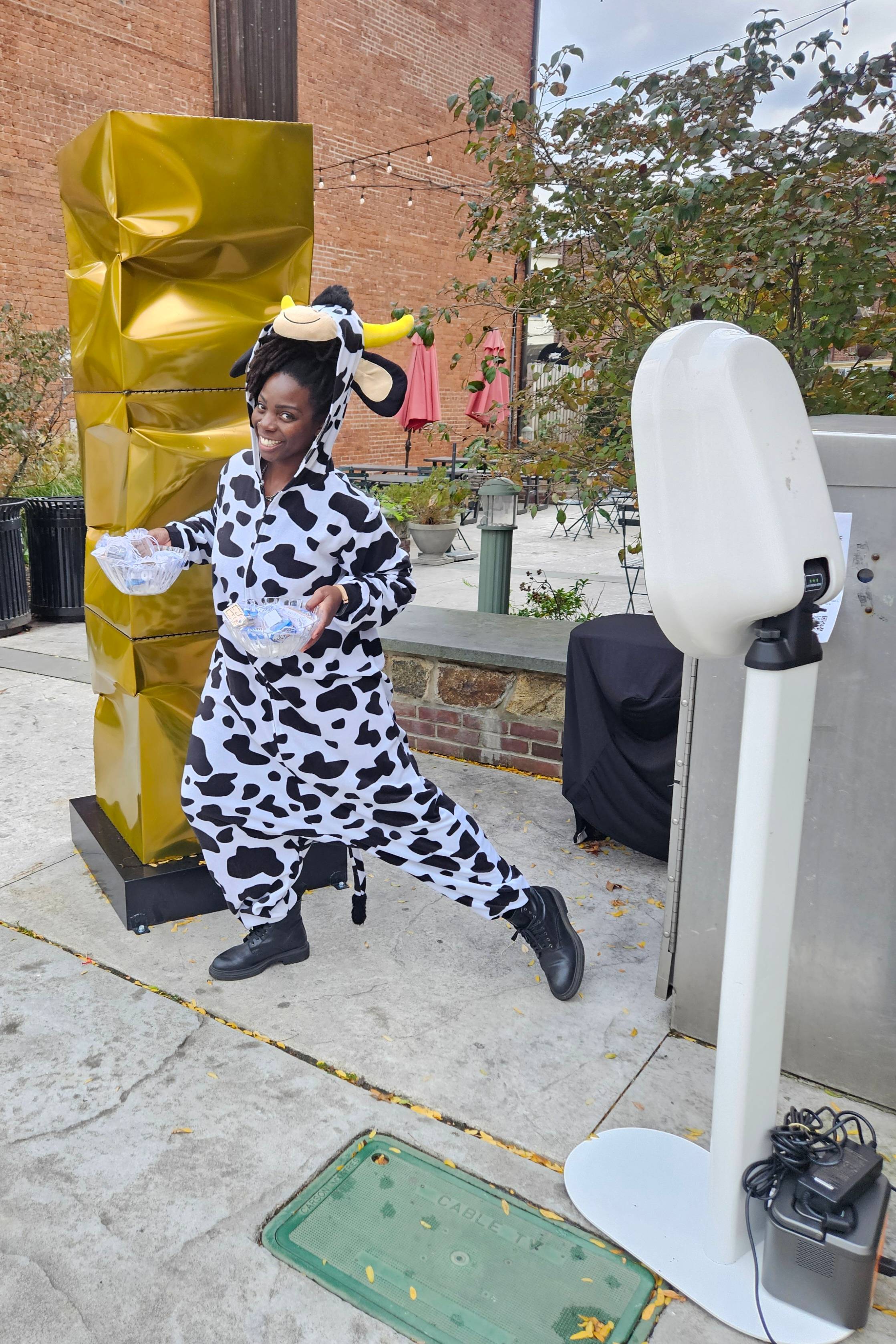 Erica Lasan in a cow costume with Irie Vibes Photobooth: Holy Halloween 2025 