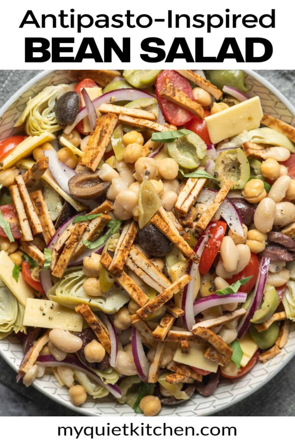 This Dense Bean Salad takes inspiration from the bold flavors of antipasto, and with a vegan twist! Packed with two types of beans, marinated veggies, olives, vegan cheese, tofu salami, and a simple Italian vinaigrette, it's the perfect make-ahead salad f