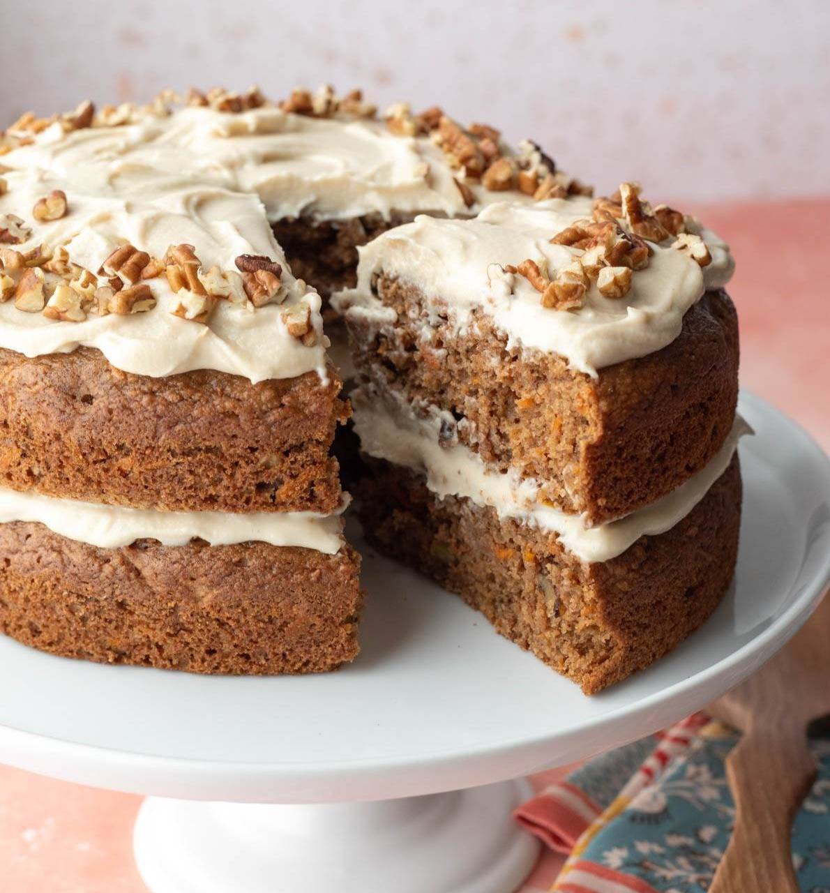 Baked and air fried tortilla chips spread out on a tray next to a cup of salsa.