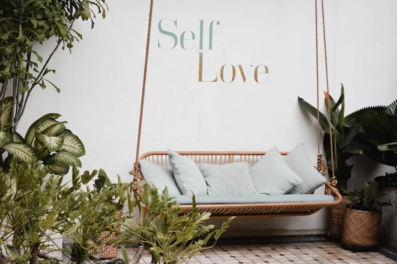 brown rattan swing bench with cushions