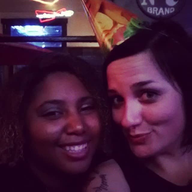 Two women smile at the camera