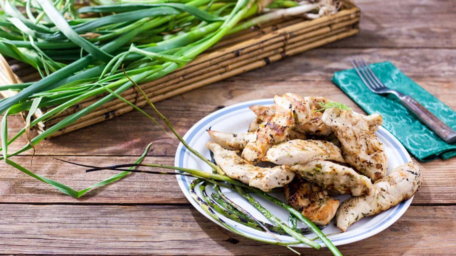 Crilled chicken tenders with grilled garlic scapes.