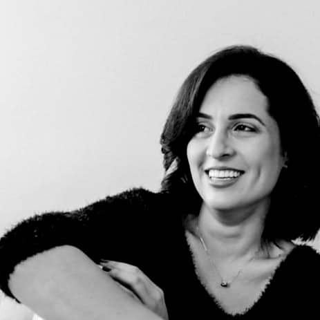 woman in black long sleeve shirt sitting on white couch