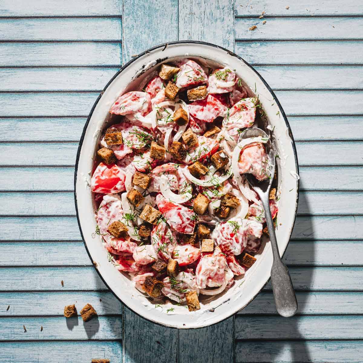 reamy tomato salad in a serving dish