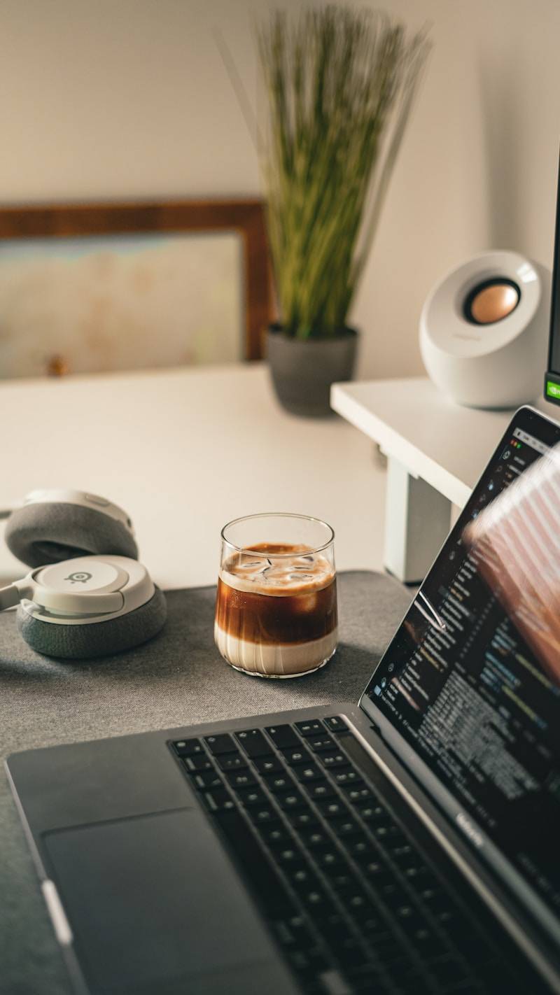 Laptop and coffee on a desk.