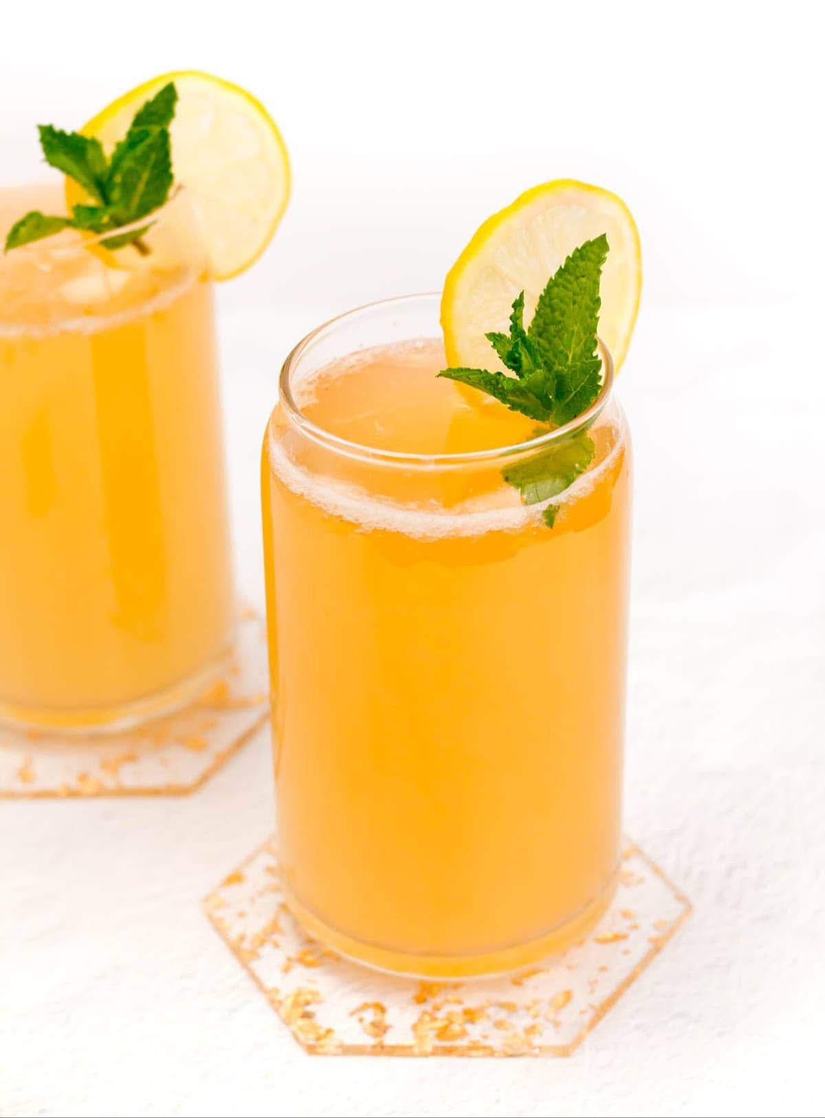 Two shandy drinks in beer can glasses