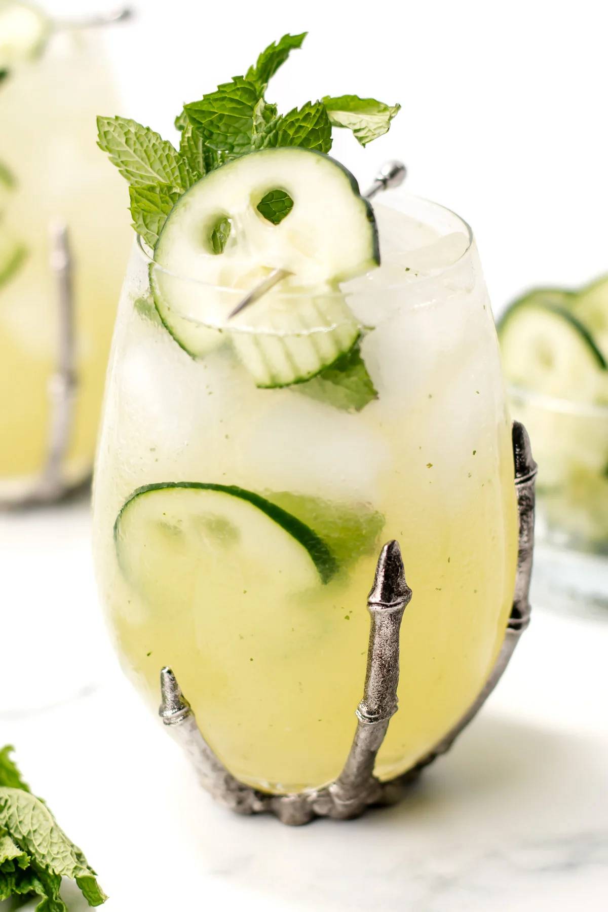 A Halloween drink with kiwi skulls garnish.