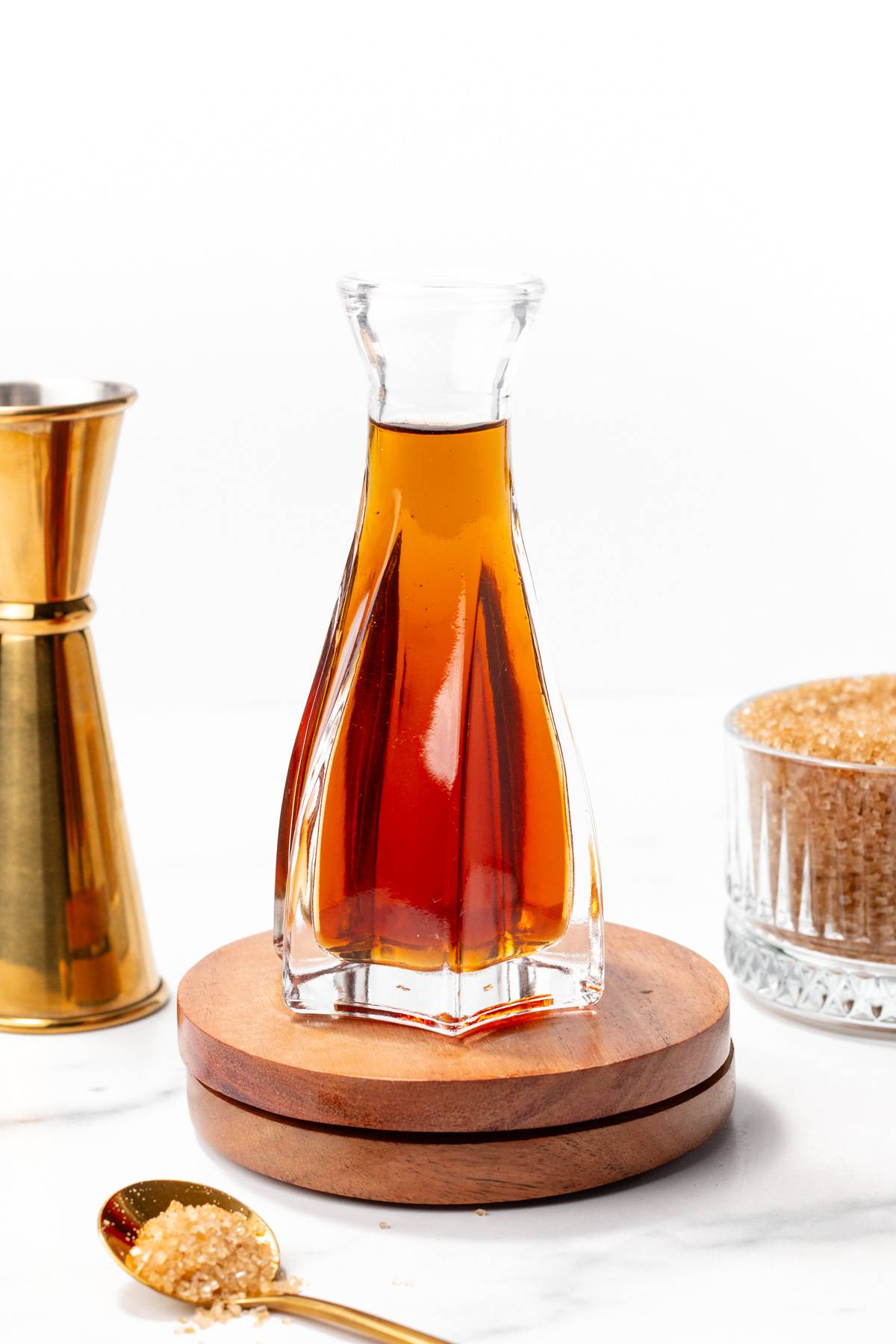 A decorative glass bottle sits on a round coaster.