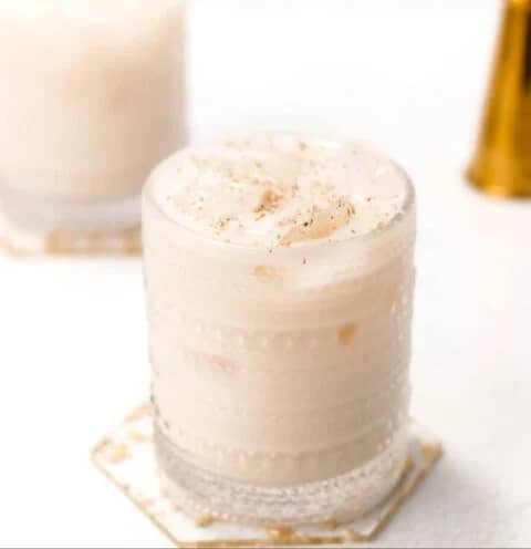 A creamy white cocktail in a glass.