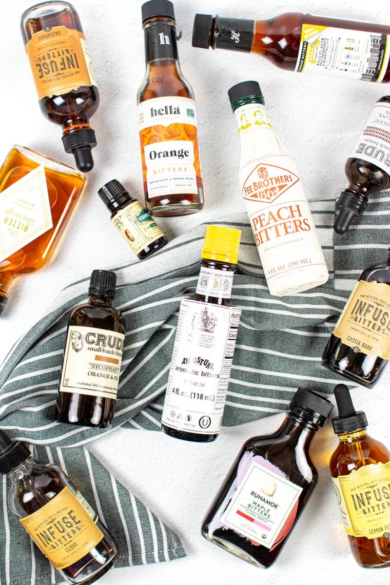 Assorted bitters sit on a gray and white striped towel.