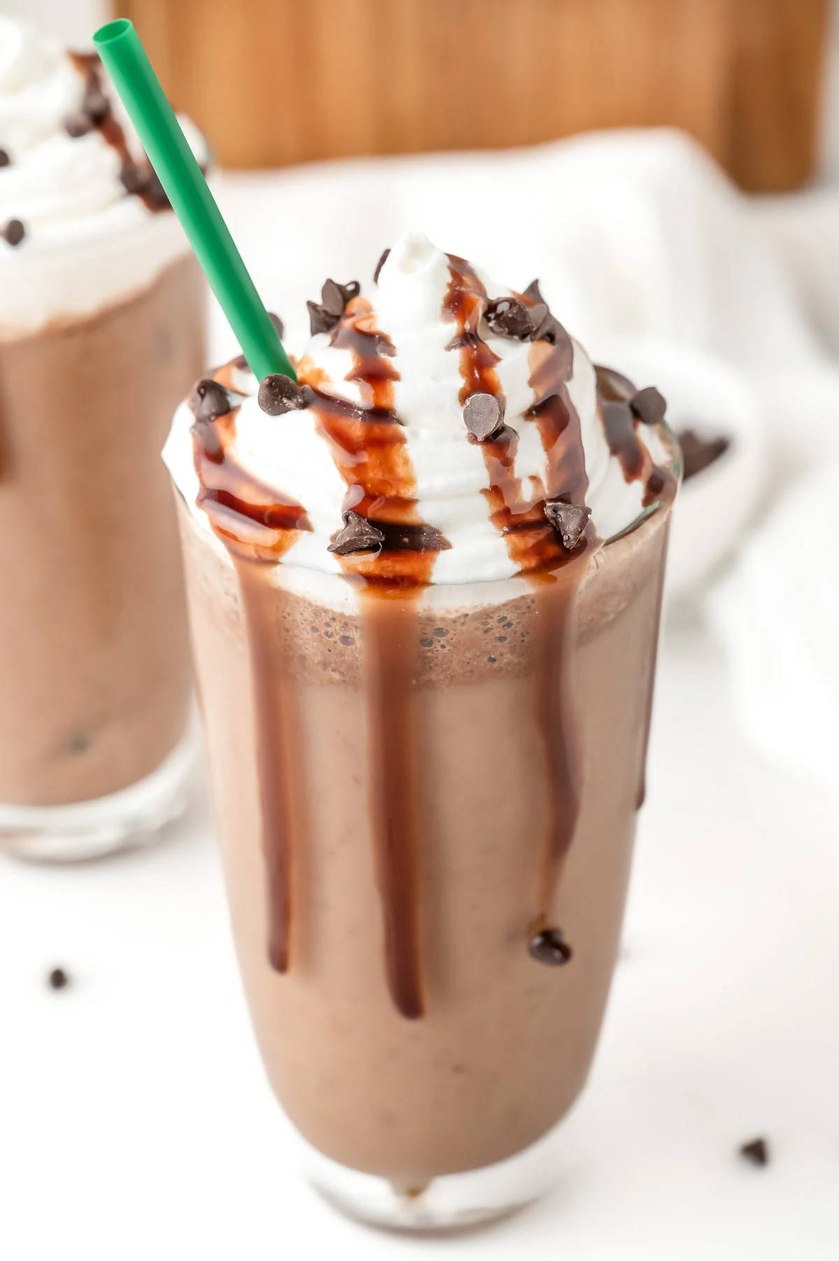 A chocolate frozen drink topped with whipped cream and chocolate chips.