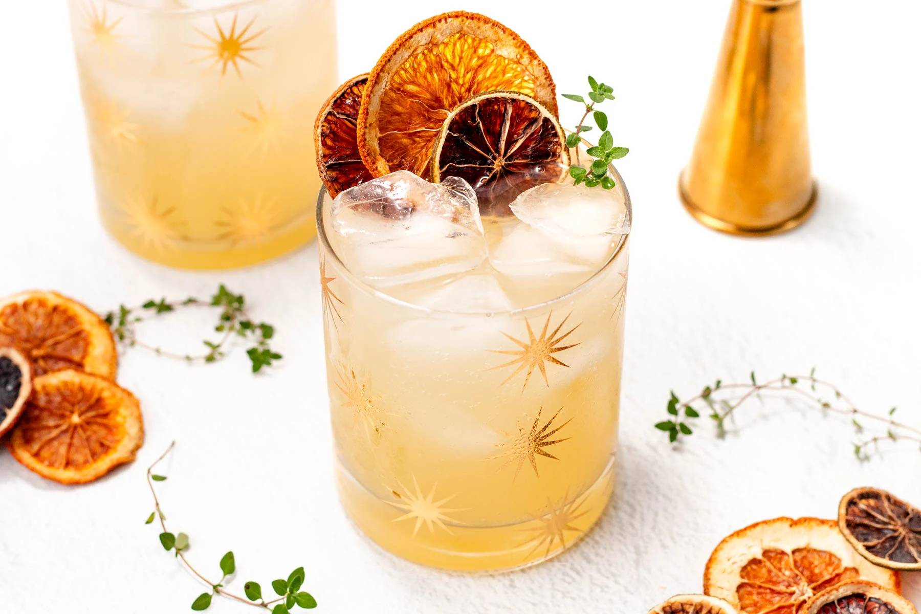 A citrus mocktail garnished with dried fruit rounds.