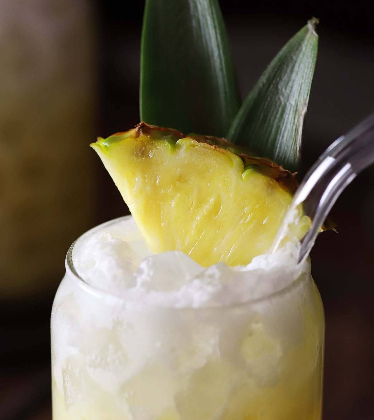 A pineapple garnish on an iced creamy drink.