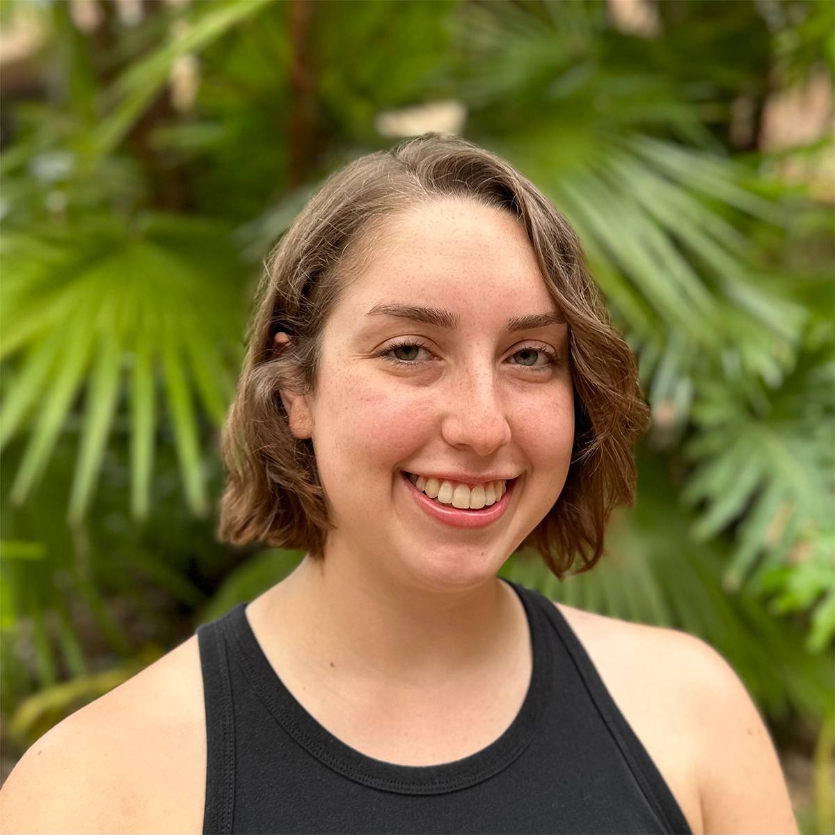 Headshot of Sarah Pilley in front of green natural background.