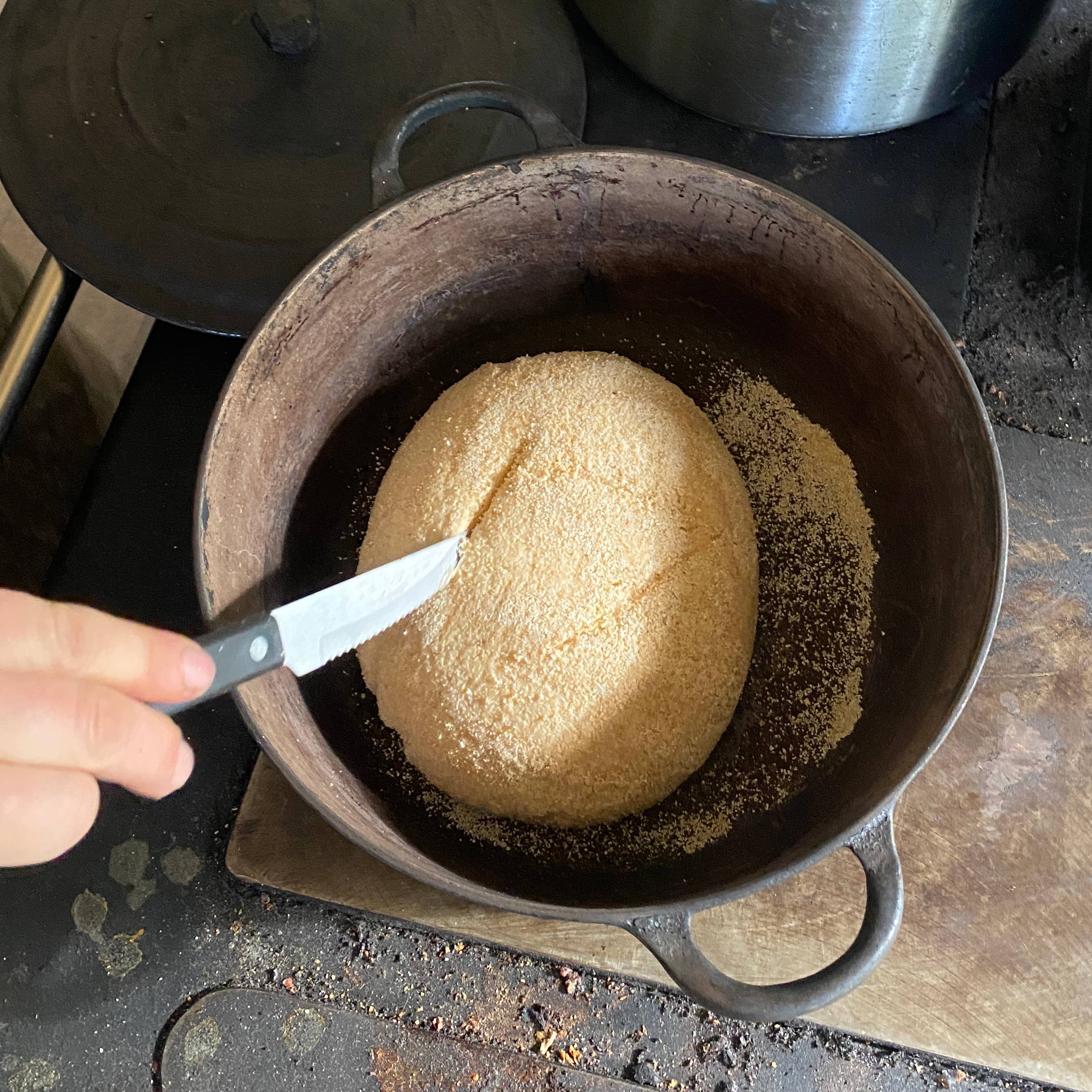 scoring a loaf of bread right before baking