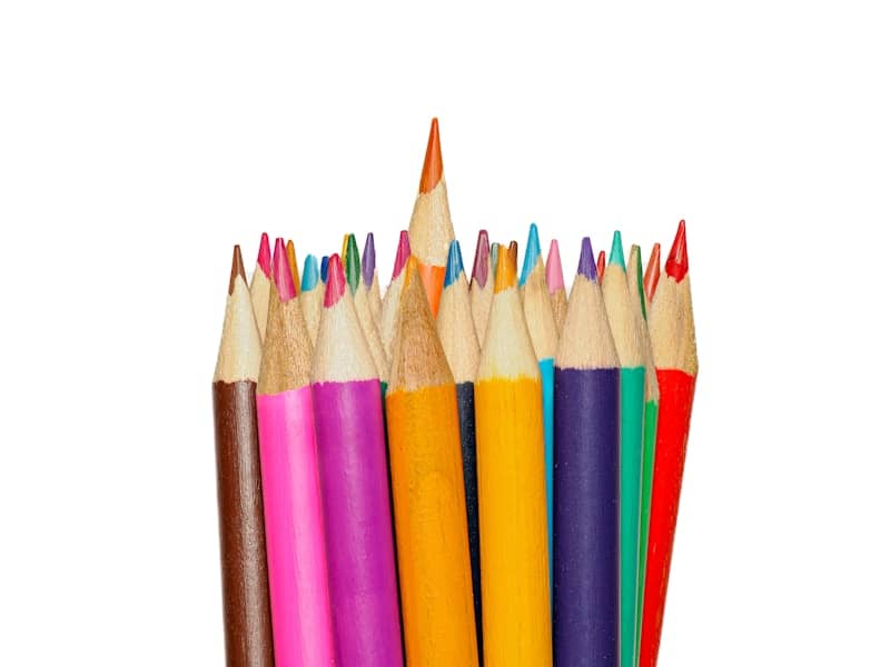 A group of colored pencils lined up in a row