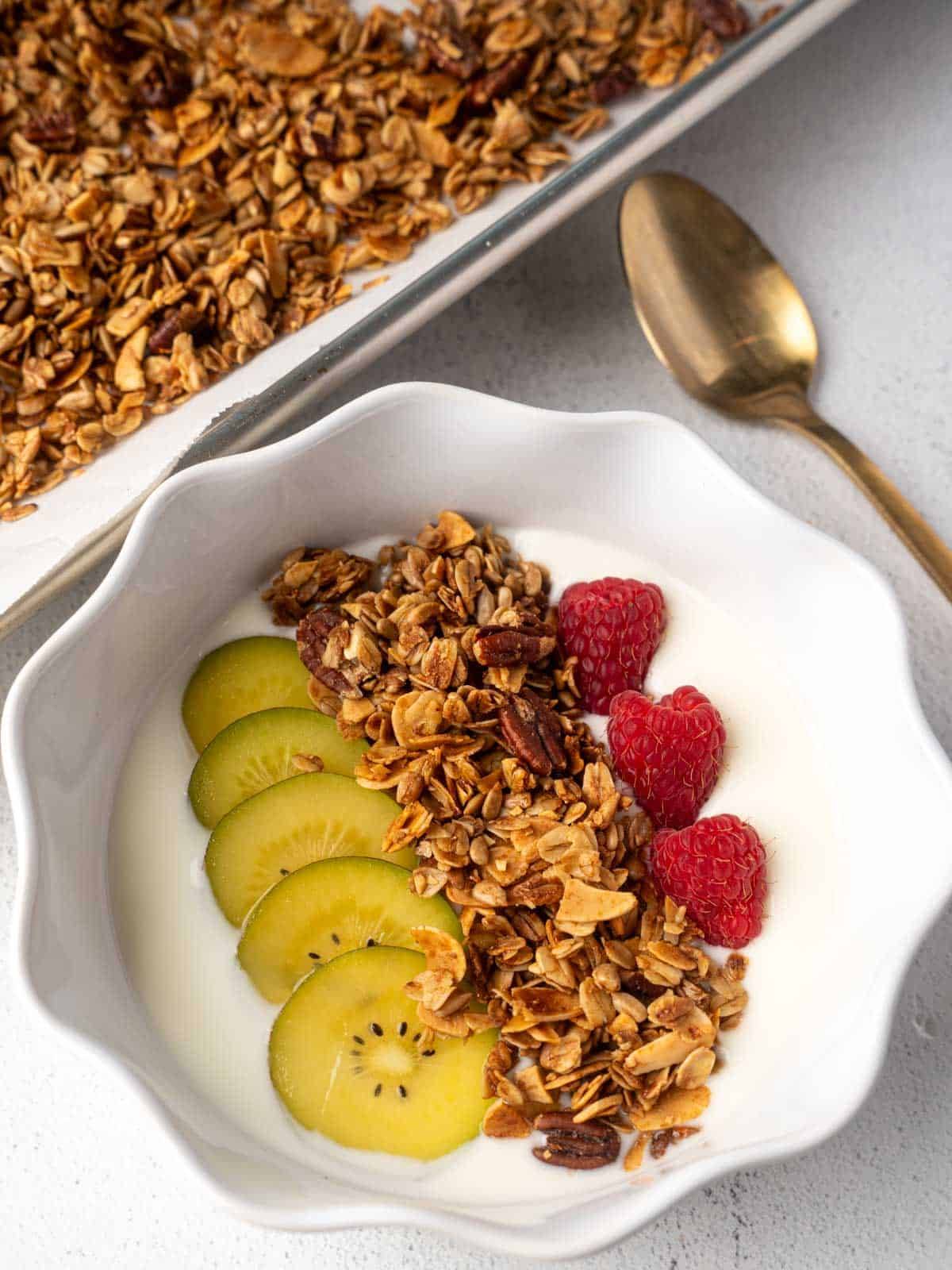 healthy granola in a bowl with kiwis yogurt and raspberries