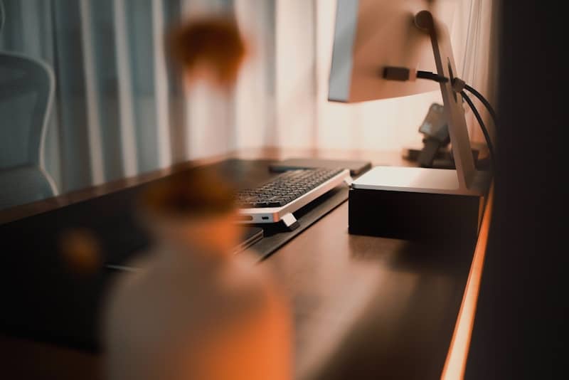 A home office desk with a computer monitor and keyboard.