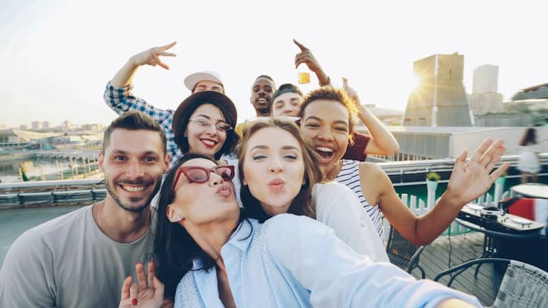 Group of friends taking a selfie on a rooftop