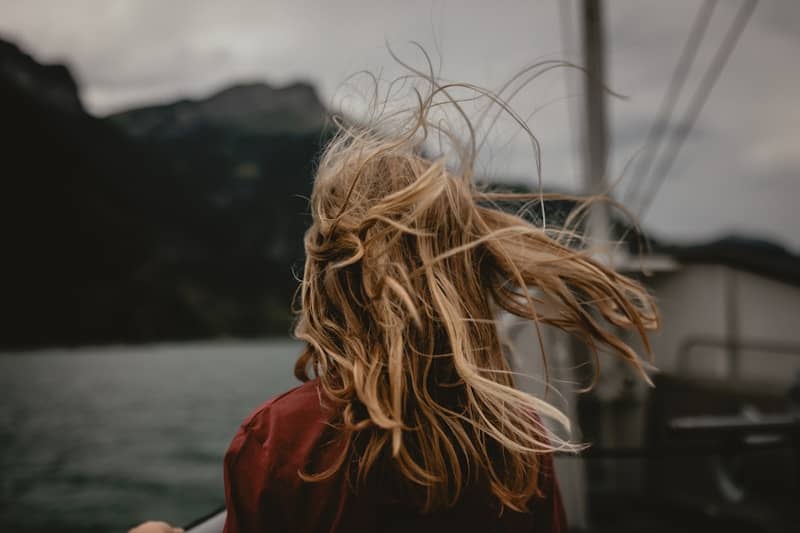 Blonde hair blows in the wind.