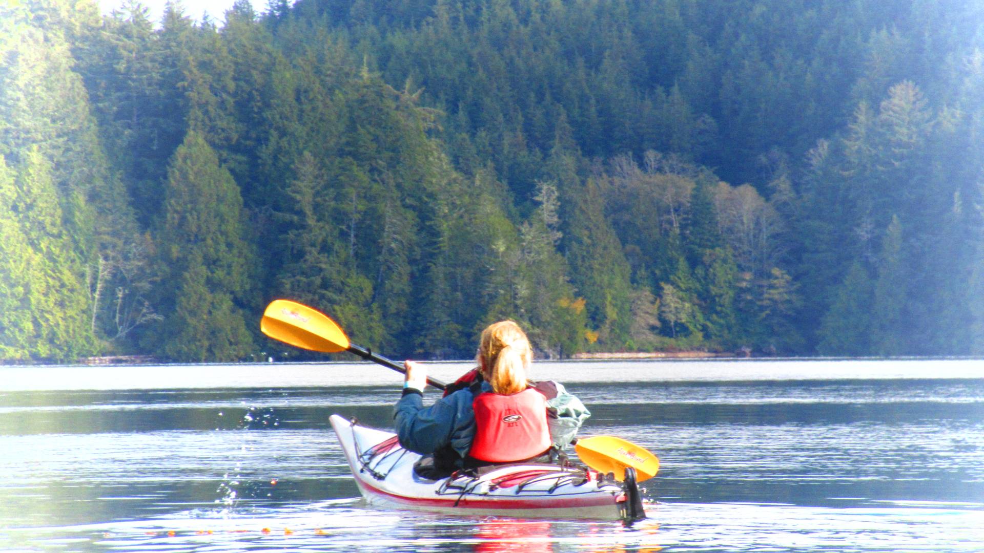 back of woman in a kayak