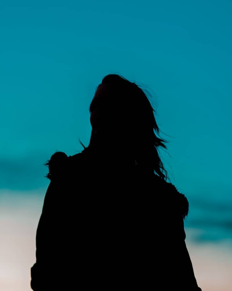 Silhouette of a person looking up at the sky
