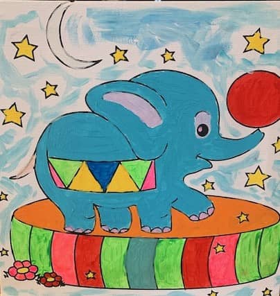 handpainted image of an elephant on a circus drum with a red ball on his nose